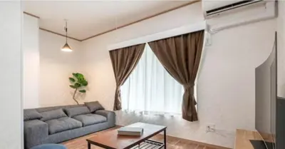 a living room with a couch and a table at \u7b39\u585a\u6238\u5efa in Tokyo