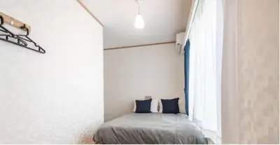 a bedroom with a bed and a window at \u7b39\u585a\u6238\u5efa in Tokyo