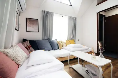 a living room with a couch and a table at SUNRISE in Tokyo