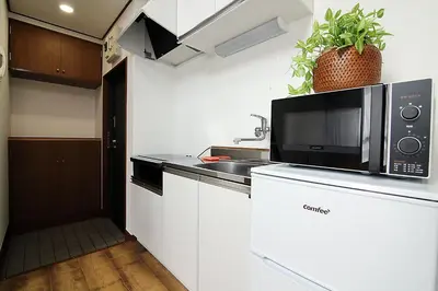 a kitchen with a microwave and a sink at SUNRISE in Tokyo