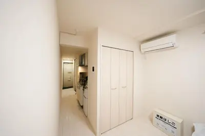a white room with a white closet and a heater at FL Residence Shinjuku II in Tokyo