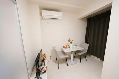 a small dining room with a white table and chairs at FL Residence Shinjuku II in Tokyo