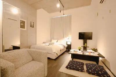 a bedroom with a bed and a couch and a table at FL Residence Seeikokan III in Tokyo