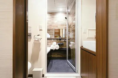 a bathroom with a shower with a sink and a toilet at 超级奢华 近秋叶原东京站Kaoa奢华套房带厨房 超豪华戴森&POLA顶级配置 4分钟到东京站 3分钟到地铁 in Tokyo