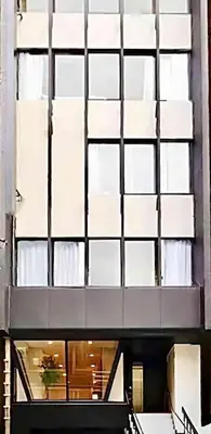 a large building with a large glass window at 都心罕见东京奢华设计师Kcob带榻榻米 戴森&POLA顶级配置4分钟到东京站 20分钟到迪士尼 最大3人 in Tokyo