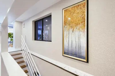 a hallway with a large painting on the wall at 都心罕见东京奢华设计师Keob带榻榻米 戴森&POLA顶级配置4分钟到东京站 20分钟到迪士尼 最大3人 in Tokyo