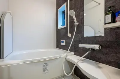 a bathroom with a shower and a white tub at THE VILLA TAKADANOBABA in Tokyo