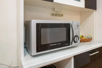 a microwave oven sitting on a counter in a kitchen at THE VILLA TAKADANOBABA in Tokyo