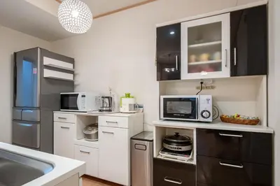 a kitchen with a sink and a microwave at THE VILLA TAKADANOBABA in Tokyo