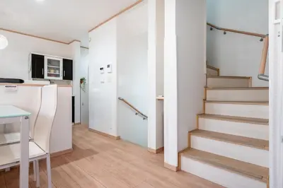 a room with stairs and a kitchen with a table at THE VILLA TAKADANOBABA in Tokyo