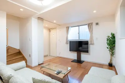 a living room with two couches and a flat screen tv at \u65b0\u5bbf6\u4e01\u76ee\u6238\u5efa in Tokyo
