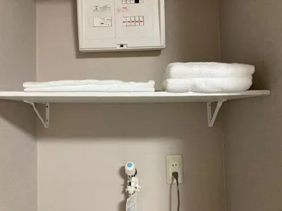 a shelf in a bathroom with towels on it at Sky Tree INN (\u6674\u6a39\u5bbf\uff09stay ASAKUSA in Tokyo