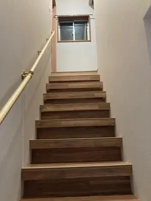 a stairway with brown wooden stairs with a window at Sky Tree INN (\u6674\u6a39\u5bbf\uff09stay ASAKUSA in Tokyo