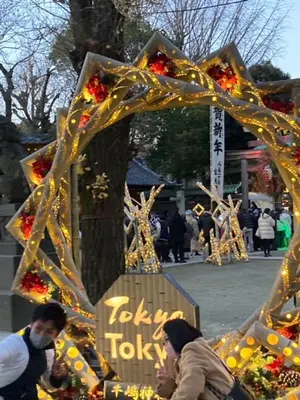 a group of people walking past a cross with flowers at Sky Tree INN (\u6674\u6a39\u5bbf\uff09stay ASAKUSA in Tokyo