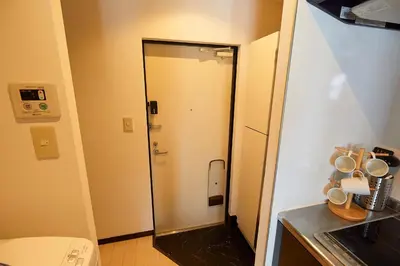 a small bathroom with a toilet and a door at \u9326\u7cfb\u753a\u5929\u7a7a\u6a39\u666f\u89c0\u98ef\u5e97 Skytree View Kinshicho - crib free in Tokyo