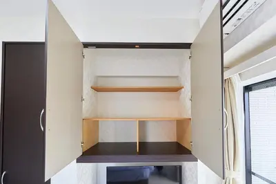 a small room with wooden shelves in a house at \u9326\u7cfb\u753a\u5929\u7a7a\u6a39\u666f\u89c0\u98ef\u5e97 Skytree View Kinshicho - crib free in Tokyo