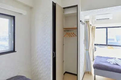 a small bedroom with a bed and a window at \u9326\u7cfb\u753a\u5929\u7a7a\u6a39\u666f\u89c0\u98ef\u5e97 Skytree View Kinshicho - crib free in Tokyo