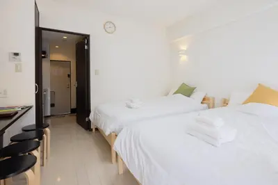 a hotel room with two beds and a desk at \u9326\u7cfb\u753a\u5929\u7a7a\u6a39\u666f\u89c0\u98ef\u5e97 Skytree View Kinshicho - crib free in Tokyo