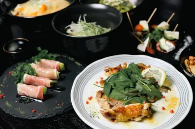 a table with a plate of food and other foods at \u4e07\u96f7\u30db\u30c6\u30eb in Tokyo