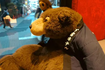 a stuffed teddy bear sitting in a store at \u4e07\u96f7\u30db\u30c6\u30eb in Tokyo