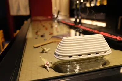 a stack of white plates sitting on a bowling lane at \u4e07\u96f7\u30db\u30c6\u30eb in Tokyo