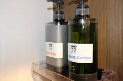 two bottles of wine sitting on a glass shelf at \u4e07\u96f7\u30db\u30c6\u30eb in Tokyo