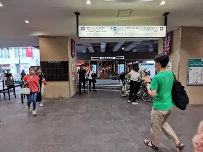 a group of people walking inside of a shopping mall at White house in Tokyo
