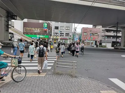 a group of people crossing a street in a city at White house in Tokyo