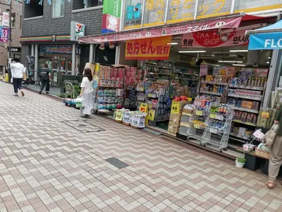 a woman standing in front of a store in a street at White house in Tokyo