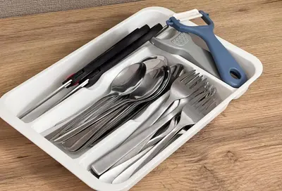 a plastic container filled with utensils on a table at \u6771\u4e0a\u91ce\u6238\u5efa in Tokyo