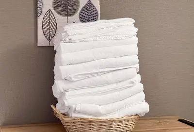 a stack of white towels in a basket at \u6771\u4e0a\u91ce\u6238\u5efa in Tokyo