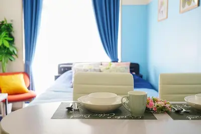a table with bowls and cups on top of it at SC 101 Cozy Private Stay with Loft Near Station Free WiFi in Tokyo