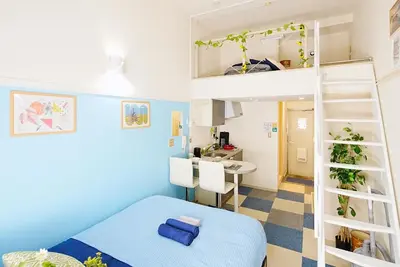 a bedroom with a bunk bed and a kitchen at SC 101 Cozy Private Stay with Loft Near Station Free WiFi in Tokyo