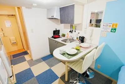 a small kitchen with a small table and chairs at SC 106 Cozy Private Stay with Loft Near Station Free WiFi in Tokyo
