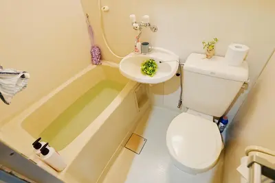 a bathroom with a toilet and a sink and a tub at SC 106 Cozy Private Stay with Loft Near Station Free WiFi in Tokyo