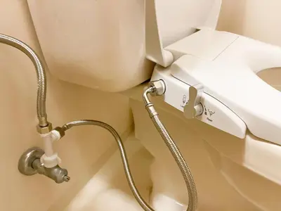 a water hose hooked up to a toilet in a bathroom at SC 106 Cozy Private Stay with Loft Near Station Free WiFi in Tokyo