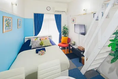 a bedroom with a white bed and a staircase at SC 106 Cozy Private Stay with Loft Near Station Free WiFi in Tokyo
