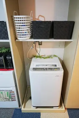 a washer and dryer sitting inside of a closet at SC 106 Cozy Private Stay with Loft Near Station Free WiFi in Tokyo