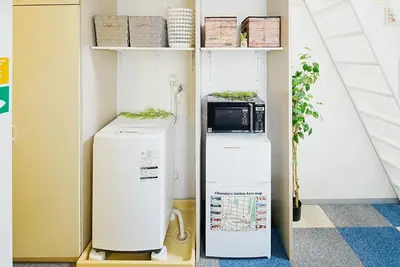 a refrigerator and a microwave in a room at SC 201 Cozy Private Stay with Loft Near Station Free WiFi in Tokyo
