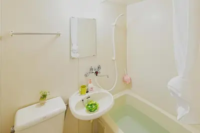 a white bathroom with a sink and a shower at SC 201 Cozy Private Stay with Loft Near Station Free WiFi in Tokyo