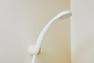 a white shower head hanging on a wall at SC 201 Cozy Private Stay with Loft Near Station Free WiFi in Tokyo