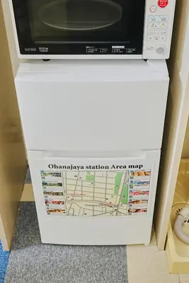 a microwave oven sitting on top of a white refrigerator at SC 203 Cozy Private Stay with Loft Near Station Free WiFi in Tokyo