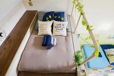 a bed in a room with pillows and a plant at SC 203 Cozy Private Stay with Loft Near Station Free WiFi in Tokyo