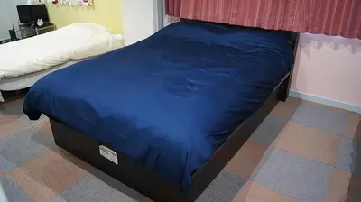 a bed with a blue comforter in a bedroom at Space Air Building 3F - Vacation STAY 11441 in Tokyo