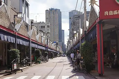 a city street with buildings and people riding bikes at Space Air Building 3F - Vacation STAY 11441 in Tokyo