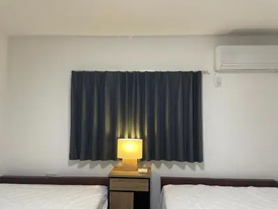 a room with two beds and a lamp and a window at Private Hotel Season Spring - Vacation STAY 71133v in Tokyo