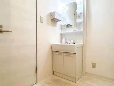 a small bathroom with a sink and a mirror at Dolce Shibuya in Tokyo