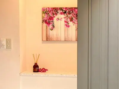 a vase on a shelf with a painting on the wall at Dolce Shibuya in Tokyo