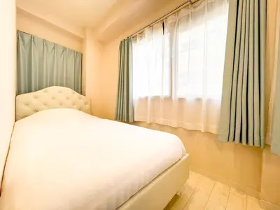 a bedroom with a white bed and a window at Dolce Shibuya in Tokyo