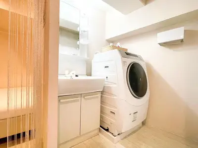 a washing machine in a bathroom with a sink at Dolce Shibuya in Tokyo